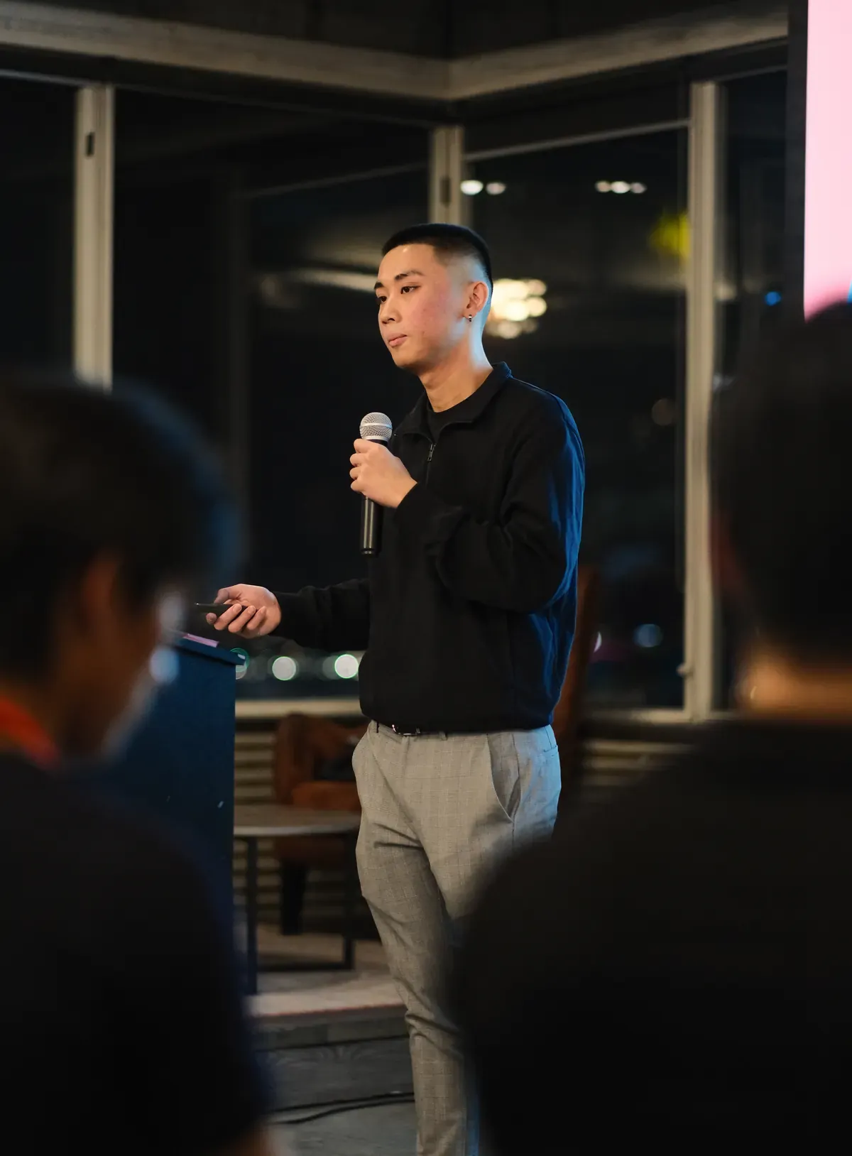 Jordan Pham speaking with a microphone